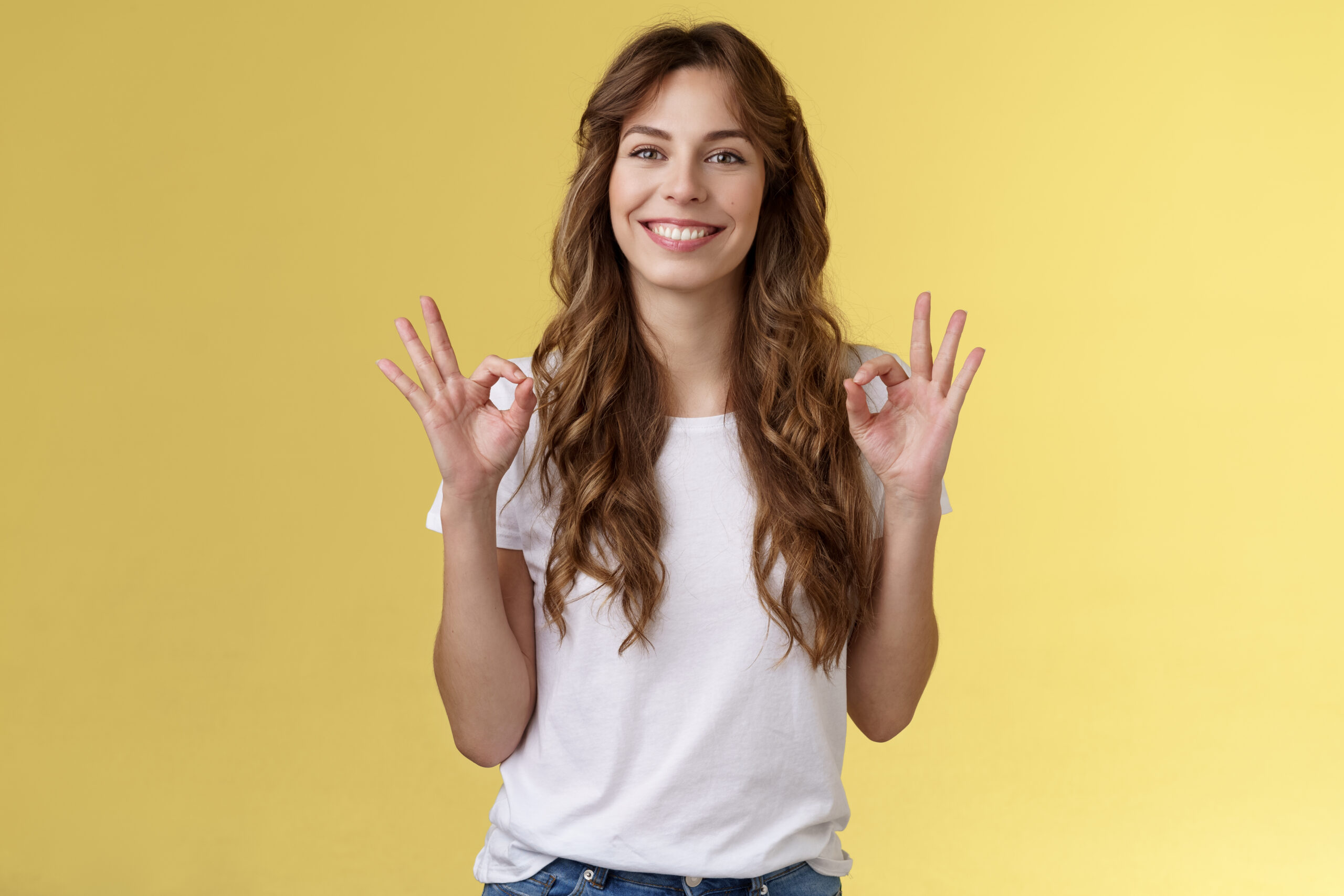 I am fine thanks asking. Cheerful relaxed smiling good-looking caucasian woman show okay rings gesture satisfied great condition recommend perfect company services stand yellow background.